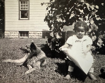 Original found photo 1935 of a young African American girl with her pet dog in the yard 4.5” x 2.75” unframed black & white photograph