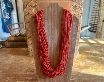Vintage Navajo inspired 1970s-1980s 28-strand coral color glass seed bead long 30” statement necklace, beautiful deep coral color