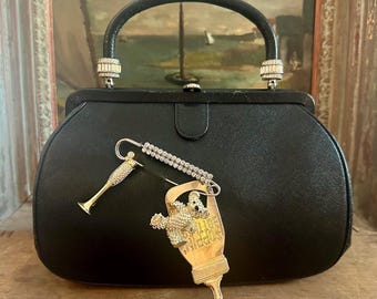 Vintage MCM 1950s iconic Bienen-Davis black purse adorned with vintage brooches for mom, champagne, teddy bear, baby bottle, one-of-a kind