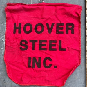 May include: Red fabric banner with the text "HOOVER STEEL INC." printed in black.