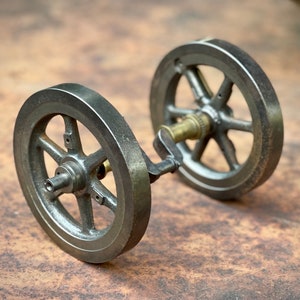 Antique industrial sculpture steel gears from a small steam engine industrial art decor.