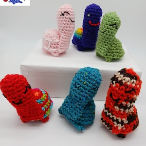 May include: Six crocheted turtle amigurumi toys in various colors, including pink, purple, green, red, blue, and orange. The turtles have big heads and are all smiling. The text "PDF Pattern Only Mini Big Head Turtle" is visible at the top of the image.