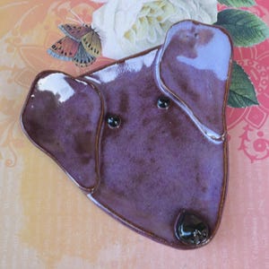 May include: A white ceramic mug with a black handle and the text "But First, Coffee" in a black, bold font. The mug is on a white surface. The mug is approximately 4 inches tall.