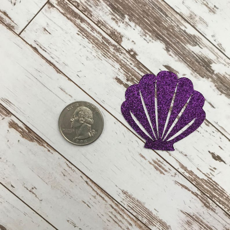 May include: Purple glitter seashell cutout. The seashell is about the size of a quarter.