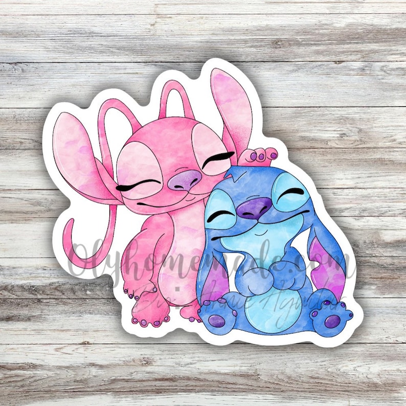 May include: A watercolour illustration of two cartoon characters, Stitch and Angel, hugging. Stitch is blue with a purple nose and Angel is pink with a purple nose. Both characters have closed eyes and are smiling.