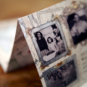 May include: A vintage scrapbook with multiple black and white photos of people. The photos are framed with decorative borders and have a faded look. The scrapbook is open to a page with a photo of three people, two girls and a man, standing together.
