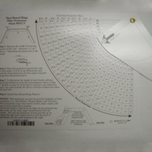 May include: A white plastic protractor with a grid pattern and a black and white diagram of a stair board. The protractor is labeled "Stair Board Rise Plus Protractor" and "Stock #2772".