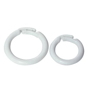 May include: Two white plastic curtain rings with a clip closure. The rings are different sizes.