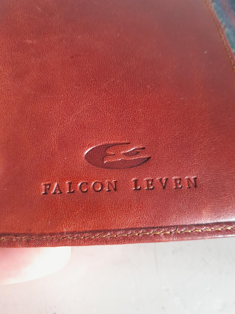 May include: A white ceramic mug with a black handle and the text "But First, Coffee" in a black, bold font. The mug is sitting on a wooden surface.