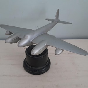 vintage aluminum model airplane on wooden base - Havilland Mosquito