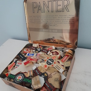 Vintage Panther cigar tin with cigar bands