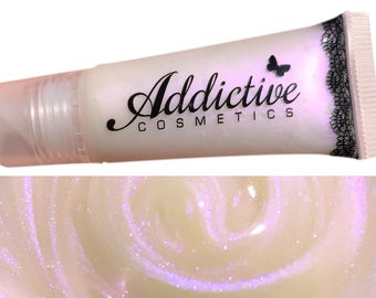 May include: A tube of lip gloss with the text "Addictive Cosmetics" in black script. The tube is white with a butterfly logo and black lace detailing. The lip gloss has a pearlescent, shimmering appearance with purple glitter.