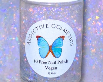 May include: A clear glass bottle with a white label that says "Addictive Cosmetics" and features a blue butterfly. The label also says "10 Free Nail Polish Vegan 15 mls". The bottle is filled with a clear, glittery liquid.