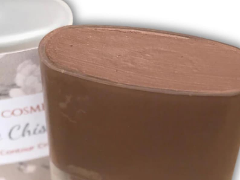 May include: A white ceramic mug with a black handle and the text "But First, Coffee" in a bold, black font. The mug is set against a neutral background, highlighting its simple design.