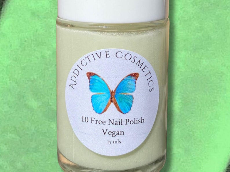May include: A small, clear glass bottle with a white label. The label has a blue butterfly design and the text "Addictive Cosmetics", "10 Free Nail Polish", "Vegan", and "15 mls".