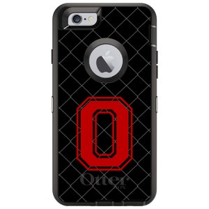 May include: Black phone case with a red "O" on a black and gray grid pattern. The case has the OtterBox logo on the bottom.
