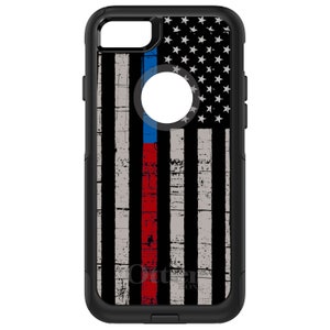 May include: Black phone case with a distressed American flag design featuring a thin red line and a thin blue line. The case is made by OtterBox.
