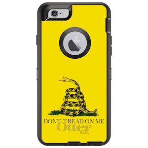 May include: A yellow iPhone case with a black snake and the words "Don't Tread On Me" and "OtterBox".
