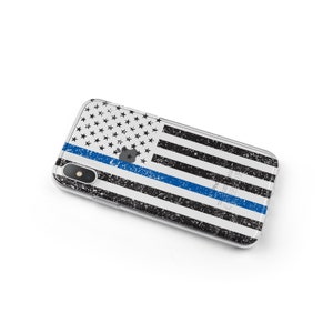 May include: A clear phone case with a distressed American flag design and a thin blue line running horizontally across the center. The case is designed for an iPhone.