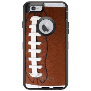 May include: A black phone case with a brown and white football design. The case has a cutout for the camera lens and a raised bezel around the screen.