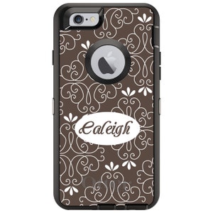 May include: A brown and white patterned phone case with a black bumper. The case has a white oval with the name "Caleigh" written in a cursive font.