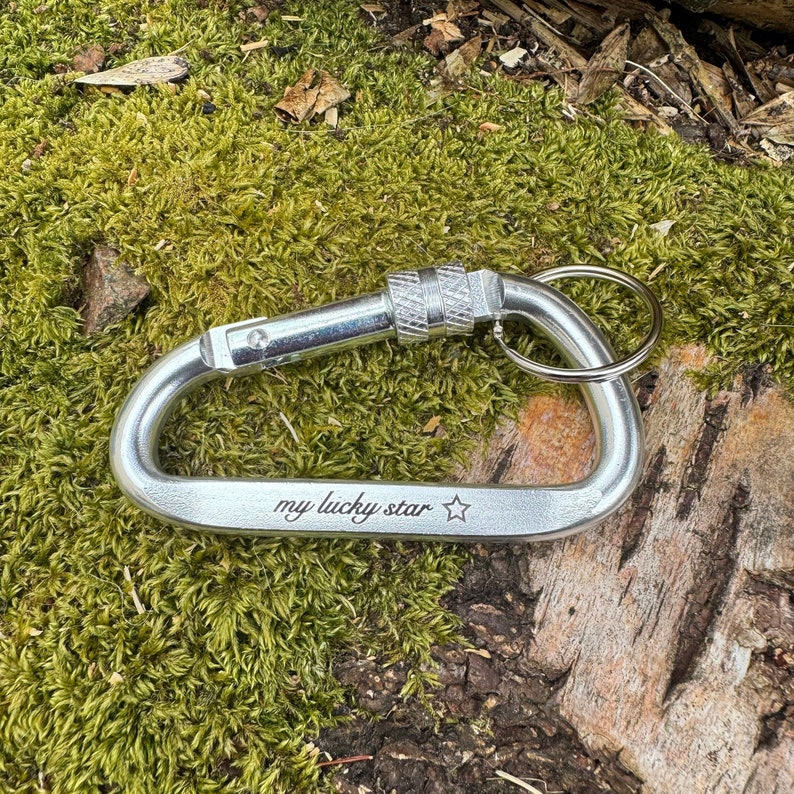 May include: Silver carabiner keychain with a ring and the words "my lucky star" engraved on the side.