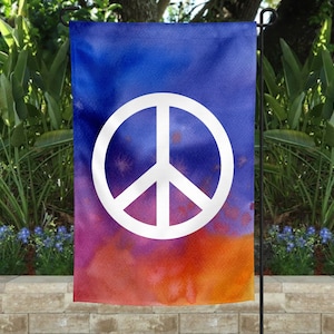 May include: A garden flag with a white peace sign on a blue, purple, orange, and red watercolor background.