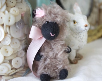 Fuzzy sheep gray sheep with pink bow and flower