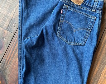May include: A pair of blue denim jeans with a Levi's Straight Fit label on the back pocket. The jeans have a classic five-pocket style and a straight leg.