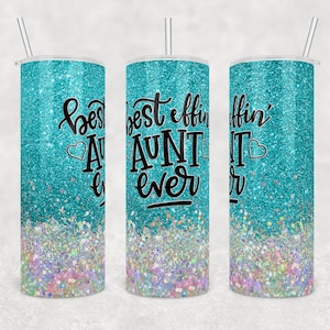 May include: Three turquoise glitter-covered tumblers with the text "best effin' AUNT ever" in black script. The bottom of the tumblers have a colorful glitter design. Each tumbler has a silver straw.