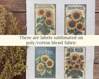May include: Four rectangular labels with sunflower illustrations and the text "FRESH PICKED" and "FRESH PICKED SUNFLOWERS". The labels are sublimated on a poly/cotton blend fabric. The text "These are labels sublimated on poly/cotton blend fabric" is also present.