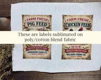 May include: Two rectangular fabric labels printed on a light-colored poly-cotton blend. The left label reads Farm Fresh Pig Feed, Anderson Farm Co., 50 lbs. net. The right label reads Farm Fresh Chicken Feed, Wilson Farm Co., 50 lbs. net.