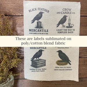 May include: Four fabric labels with crow illustrations and text. The labels read "Black Feather Mercantile," "Crow and Candle Co.," "Mercantile," and "Trading Post." The text "These are labels sublimated on poly/cotton blend fabric" is also present.