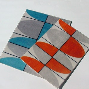 May include: Two geometric patterned rugs with a white background. One rug has orange and gray shapes, the other has blue and gray shapes.