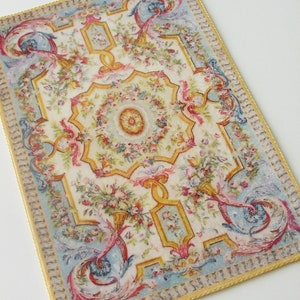 May include: A vintage-style rug with a floral pattern in shades of pink, yellow, blue, and green. The rug has a gold border and a central medallion.