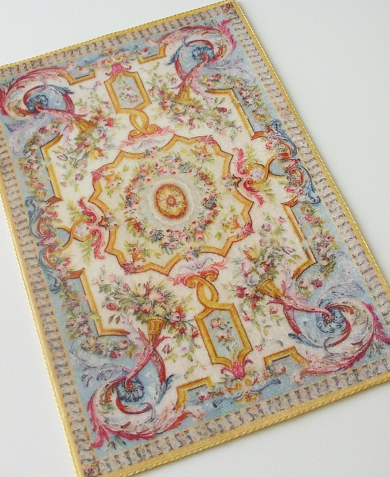 May include: A vintage-style rug with a floral pattern in shades of pink, yellow, blue, and green. The rug has a gold border and a central medallion.
