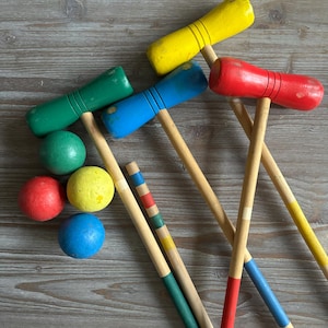 Vintage croquet mallets, Wooden colored sticks and balls, Mid century