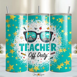 Pode incluir: Um copo azul turquesa com estrelas douradas e o texto "Teacher Off Duty" em branco. O copo tem um par de óculos de sol com montanhas e uma maçã vermelha nas lentes.