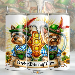 May include: White tumbler featuring three Yorkshire Terriers in Bavarian outfits, including green hats and blue and white checkered shirts. The design includes a beer mug and the text "October Drinking Team..."