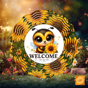 May include: A decorative wind spinner featuring a cartoon bee holding a sunflower, with the word "WELCOME" in white. The spinner has a sunflower and green leaf design around the edges. The bee has large eyes and is set against a blurred background of flowers and grass.