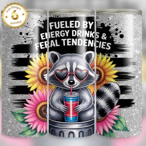 Funny raccoon drinking energy drink in trash can with sunflowers, grungey background with silver glitter, text 'Fueled by Energy Drinks and Feral Tendencies', tumbler wrap PNG.