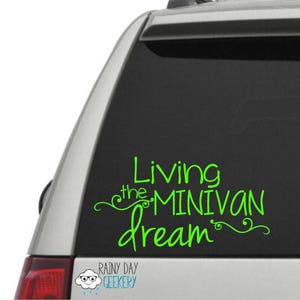 May include: Green vinyl decal on a car window. The decal reads "Living the MINIVAN dream" in a whimsical font. The Rainy Day Geekery logo is at the bottom.