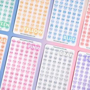 May include: Eight rectangular sticker sheets labeled Annotation Emojis, each featuring rows of small circular icons in green, yellow, blue, red, orange, pink, gray, and purple. Each sheet displays various facial expressions and symbols.