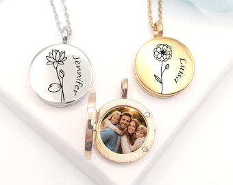 May include: Three circular locket necklaces on chains. One silver locket is engraved with a flower and the name Jennifer. One gold locket is engraved with a flower and the name Luisa. One open gold locket displays a colour photograph of a family.
