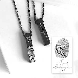 May include: Two black metal bar pendants on matching black chains. One pendant is engraved with the word Dad and a fingerprint. The other pendant features the script text always xx. A rectangular card displays a fingerprint and the text Dad always xx.