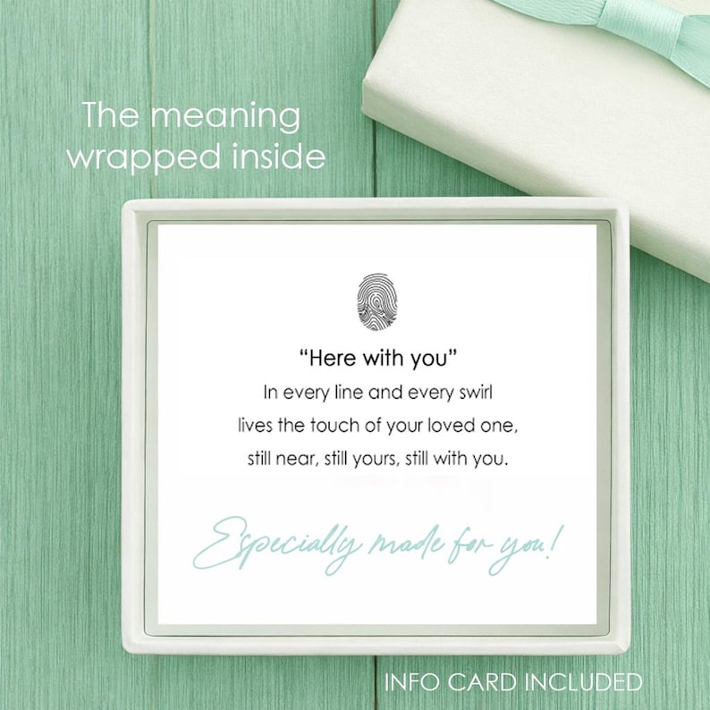 May include: A square white gift box containing a card with a black fingerprint icon and the text: Here with you, In every line and every swirl lives the touch of your loved one, still near, still yours, still with you. Especially made for you!