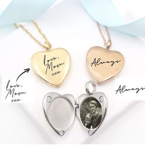 May include: Three heart-shaped lockets on chains in gold, rose gold, and silver tones. The gold locket is engraved with "love, Mom xxx" and the rose gold locket with "Always". The silver locket is open, revealing a black and white photograph inside.