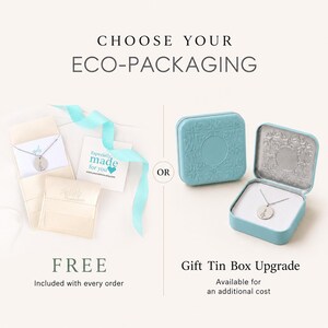 May include: A comparison of packaging options featuring a necklace on a white card with a light blue ribbon and a square light blue embossed metal tin box. Text reads CHOOSE YOUR ECO-PACKAGING, FREE, and Gift Tin Box Upgrade.