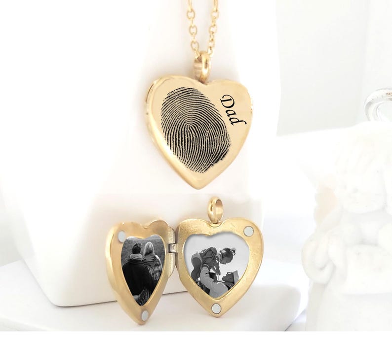 Gold heart-shaped locket necklace with fingerprint and 'Dad' engraved on one side. The other side is a hinged locket that opens to reveal a photo of two people.  The necklace is non-tarnish and available in gold, silver, and rose gold.