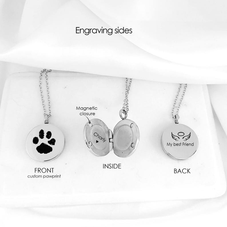 May include: Three silver-toned circular locket necklaces with chains. The front shows a black paw print, the open middle locket reveals a magnetic closure and the name Charly, and the back features angel wings with the text My best Friend.